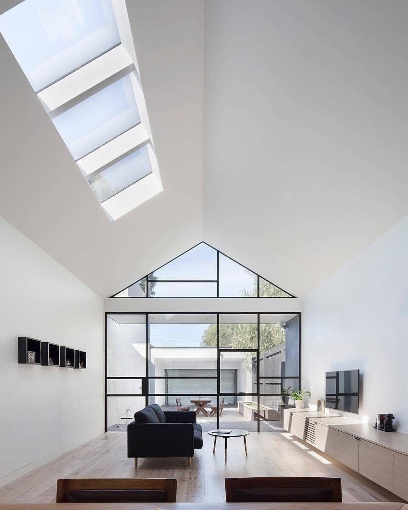Minimalist living room with huge skylights that let in lots of light