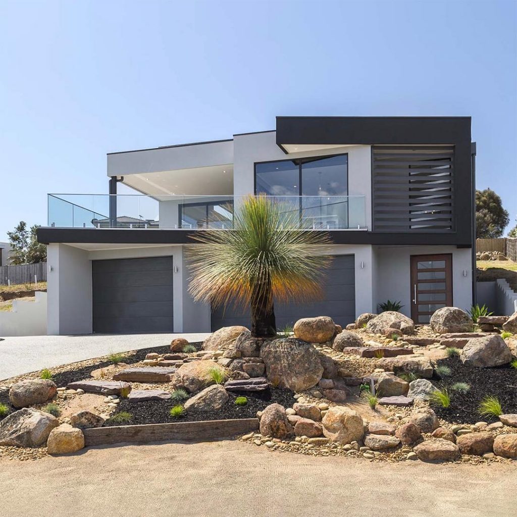 This dramatic angled facade is characterized by a mix of light and dark plaster